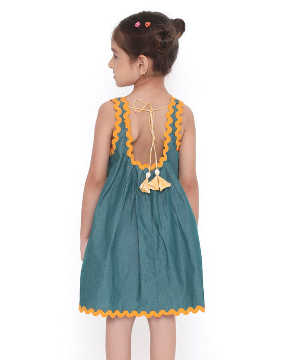 Young girl in a sleeveless Lagoon striped Mangalgiri cotton dress with yellow lace trims and a patch pocket.