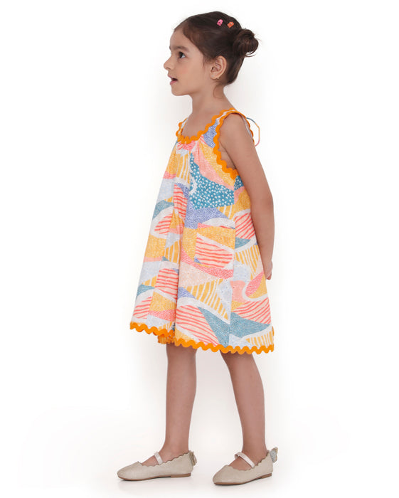 Young girl wearing a colorful Whimsy Hills limited edition sleeveless dress with Schiffli cotton embroidery and yellow lace trim