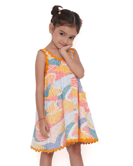 Young girl wearing a colorful Whimsy Hills limited edition sleeveless dress with Schiffli cotton embroidery and yellow lace trim