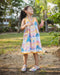 A colourful Whimsy Hills limited edition dress with Schiffli cotton embroidery and yellow lace trim, worn by a young girl