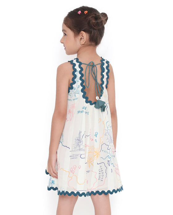 Young girl wearing a sleeveless Voyager Trails cotton dress with multicolour map print and blue lace trim, standing with arms outstretched.