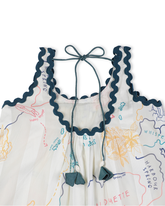 Close-Up view of a Voyager Trails cotton dress with multicolour map print, blue lace trim, and tassel tie-up detail