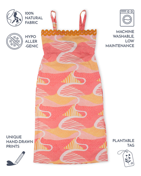 Candy Escape Midi Dress with vibrant pink and yellow hand-drawn print, featuring yellow lace trim, adjustable straps, and plantable tag. Made from 100% natural, hypoallergenic cotton fabric, machine washable for easy care