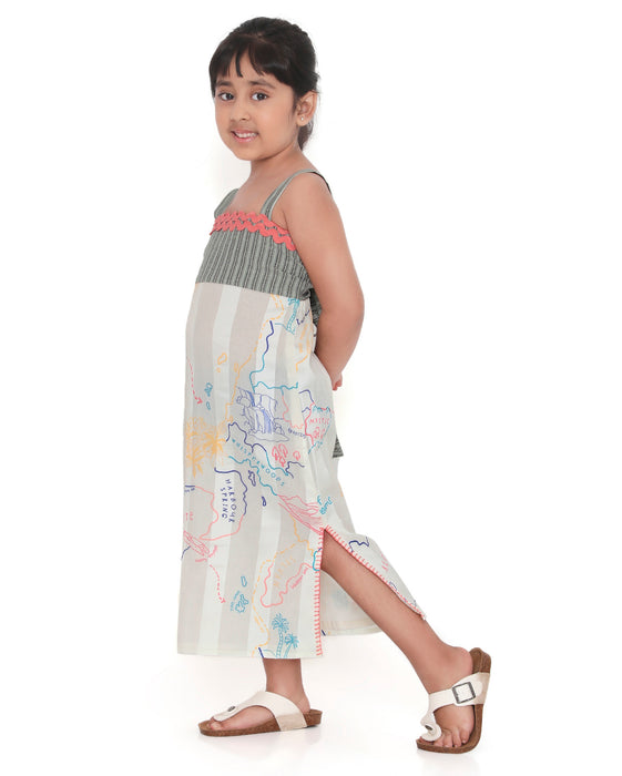 Young girl wearing a Voyager Trails midi dress with a multicolour map print, green striped bodice, and pink lace trim, posing confidently.