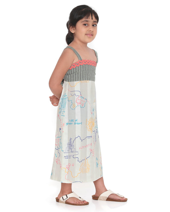 Young girl wearing a Voyager Trails midi dress with a multicolour map print, green striped bodice, and pink lace trim, posing confidently.